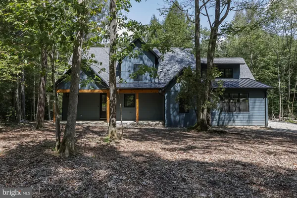 a view of a house with a tree in the yard
