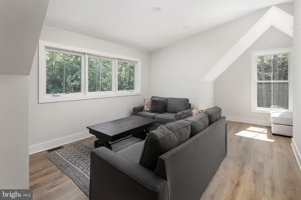 a living room with a bed furniture and a window
