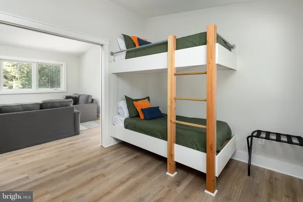 a bathroom with a granite countertop sink a mirror and shower