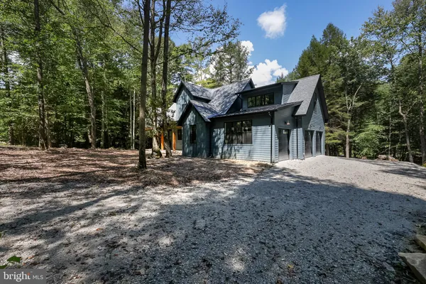 a view of a porch with furniture and wooden floor