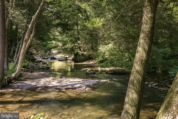 a sitting area with furniture and wooden floor