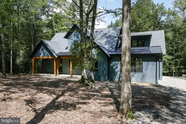 a living room with furniture a fireplace and a large window