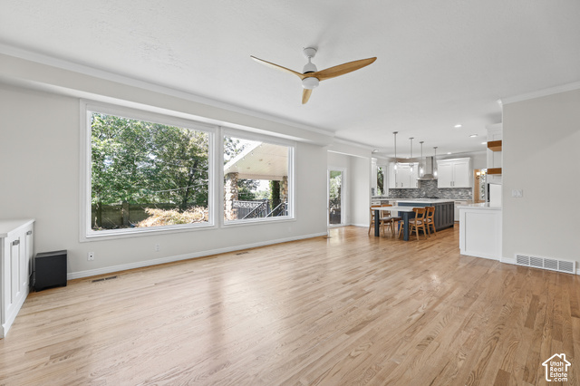 10664 Trail Ridge Circle Sandy, UT 84092 - Photo 18 of 113 Expansive wood-finish flooring with a modern ceiling fan and large picture windows