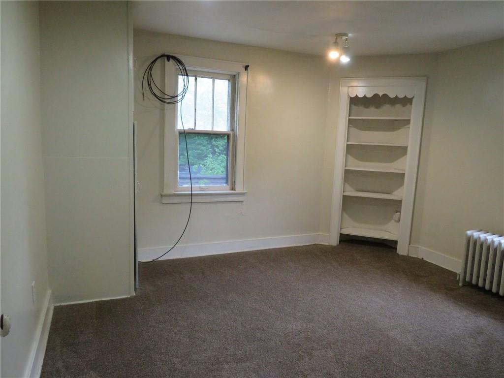 423 Braddock Road Pittsburgh, PA 15221 - Photo 26 of 36 an empty room with a window and a ceiling fan