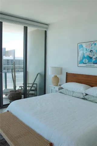 a bedroom with a large bed and a large window