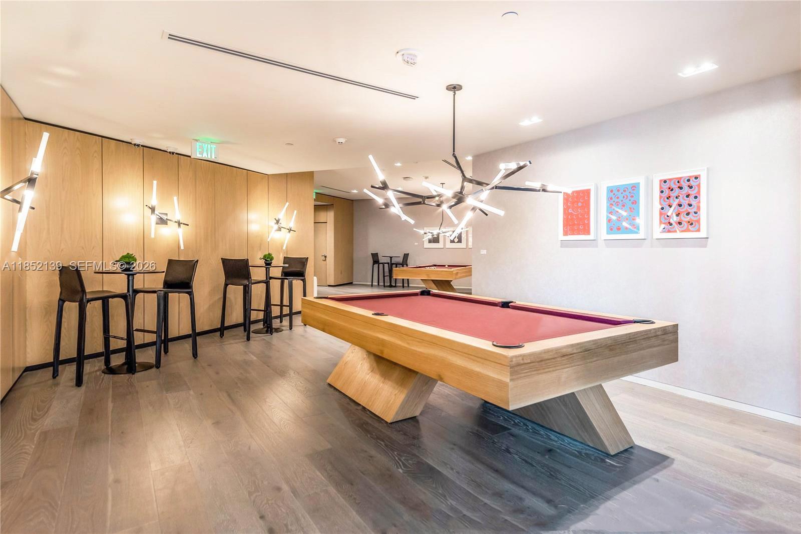 480 Northeast 31st Street, Unit 3301 Miami, FL 33137 - Photo 27 of 32 a room with wooden floor pool table and chairs