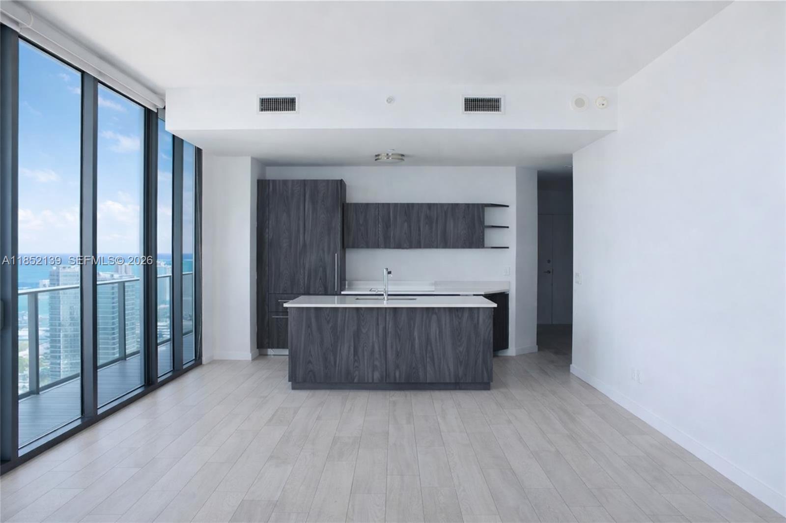 480 Northeast 31st Street, Unit 3301 Miami, FL 33137 - Photo 3 of 32 a room with a vanity and mirror