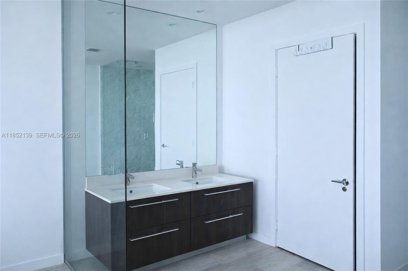 480 Northeast 31st Street, Unit 3301 Miami, FL 33137 - Photo 8 of 32 a bathroom with a sink and a mirror