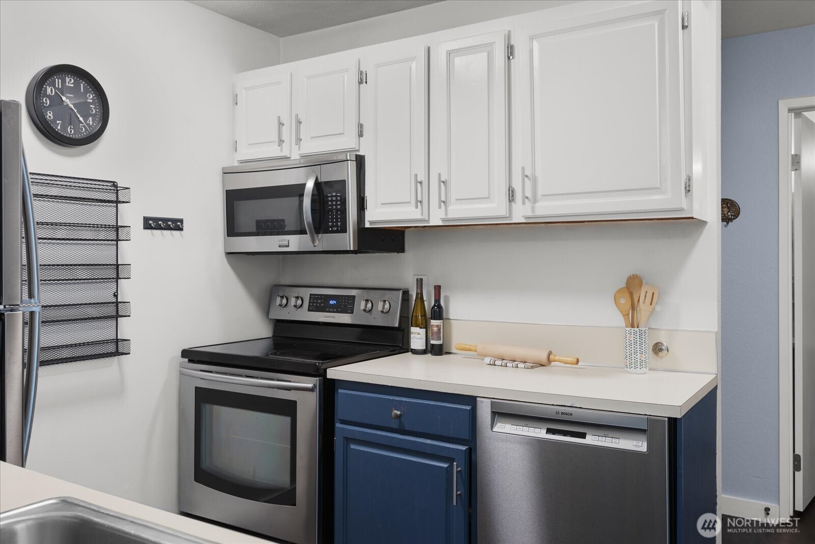 3024 Northeast 143rd Street, Unit 305 Seattle, WA 98155 - Photo 13 of 17 a kitchen with cabinets stainless steel appliances and a sink