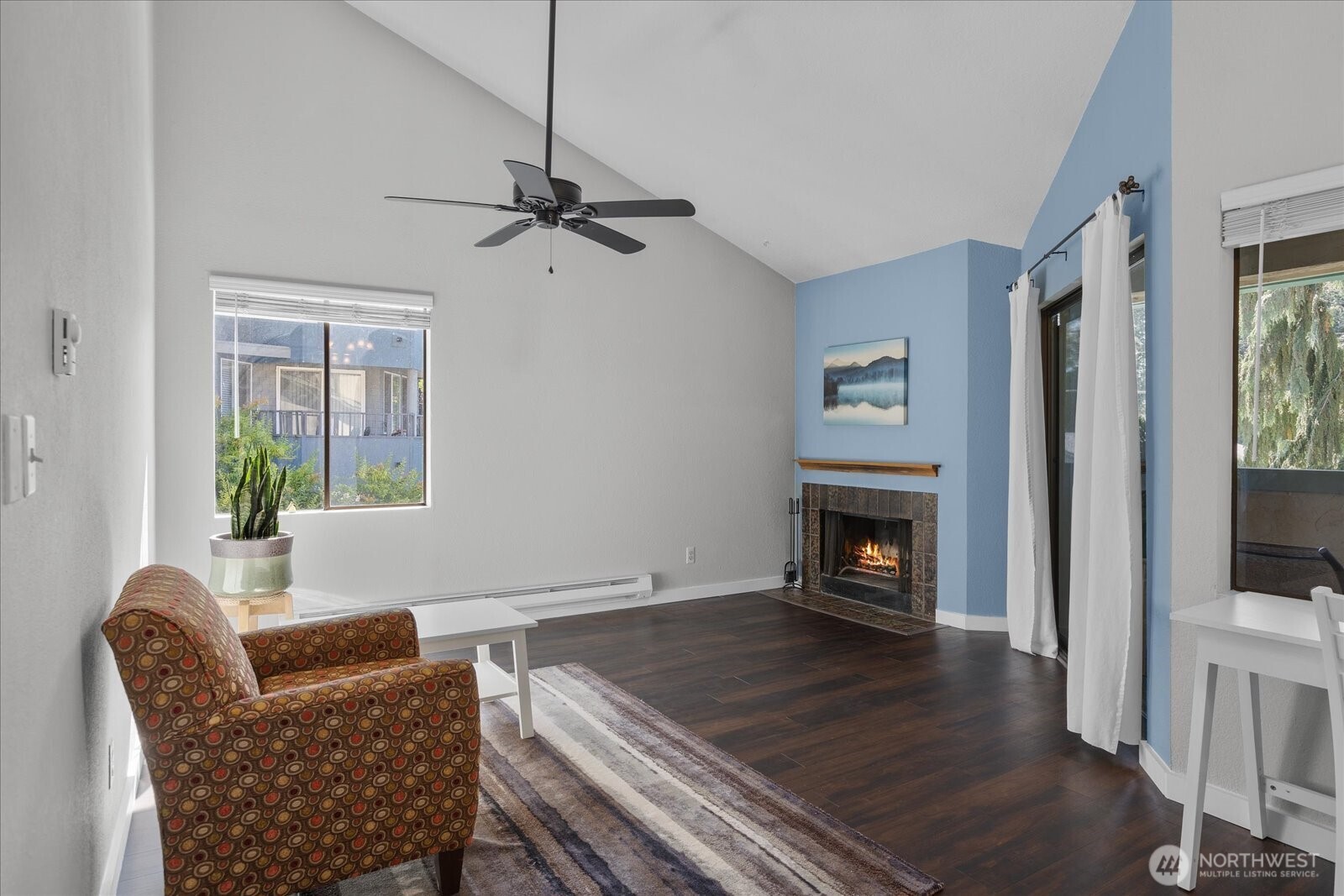 3024 Northeast 143rd Street, Unit 305 Seattle, WA 98155 - Photo 2 of 17 a living room with furniture and a fireplace