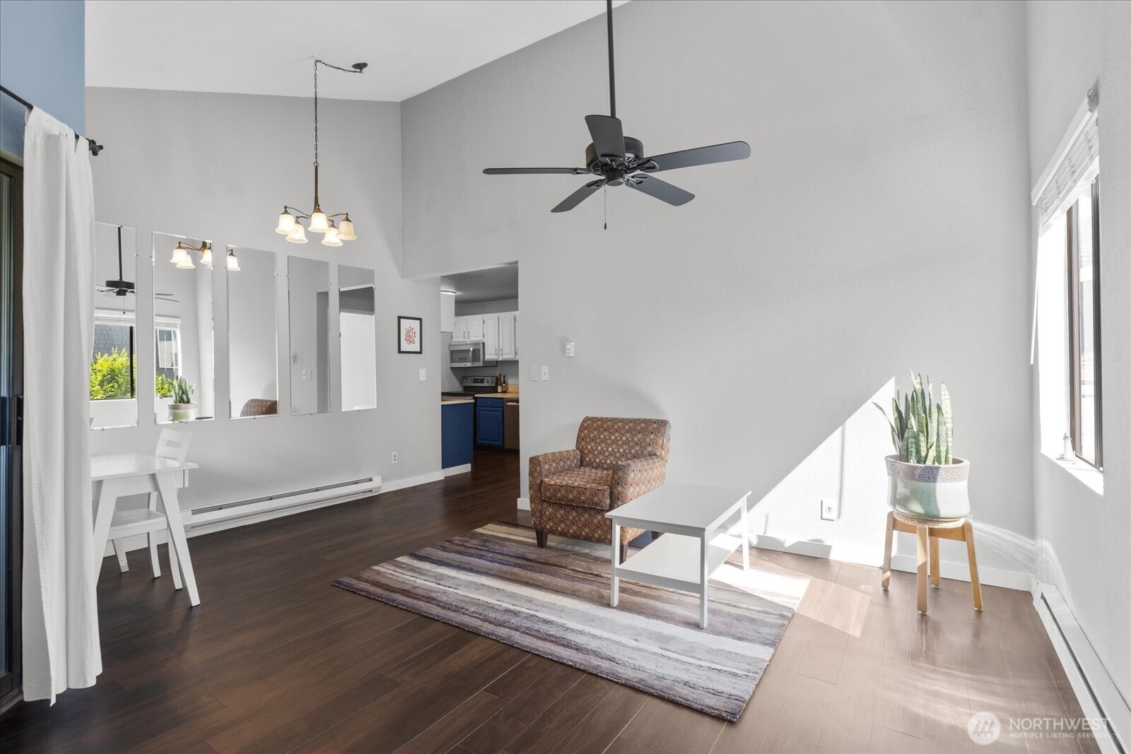 3024 Northeast 143rd Street, Unit 305 Seattle, WA 98155 - Photo 4 of 17 a living room with furniture and a chandelier