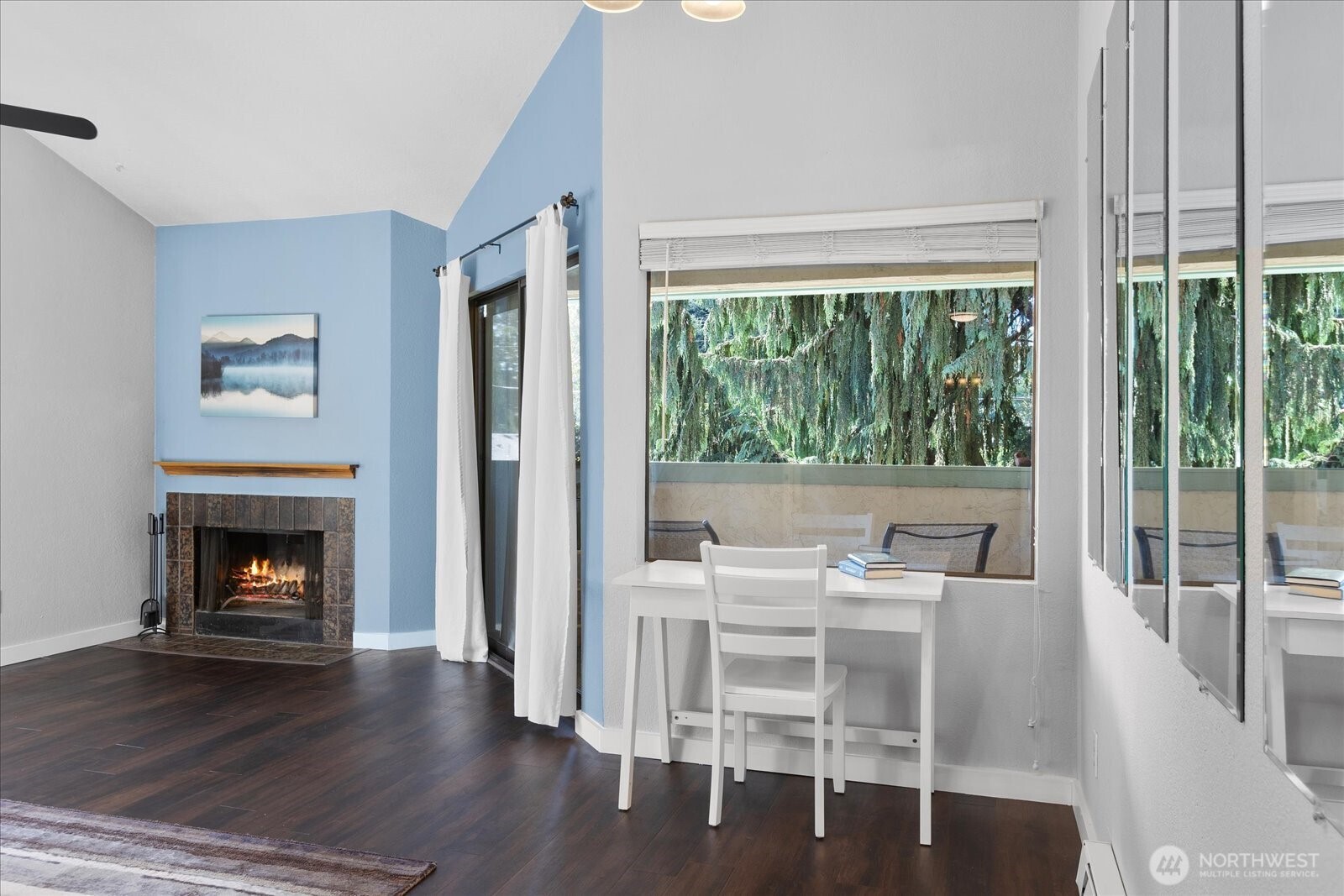 3024 Northeast 143rd Street, Unit 305 Seattle, WA 98155 - Photo 6 of 17 a living room with furniture a fireplace and a floor to ceiling window