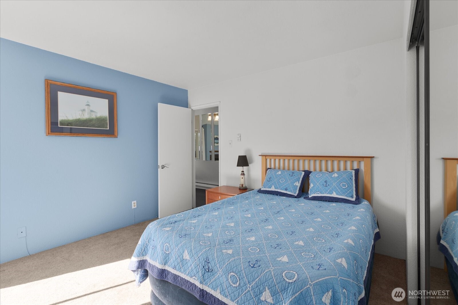 3024 Northeast 143rd Street, Unit 305 Seattle, WA 98155 - Photo 8 of 17 a bed sitting in a bedroom next to a window