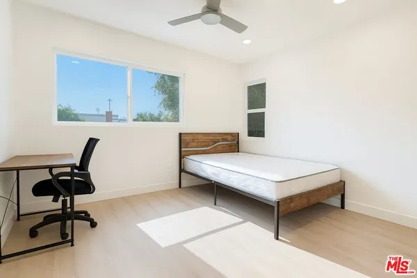 a living room with a window piano and a table