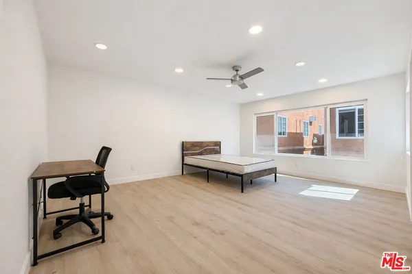 a living room with furniture and a piano table