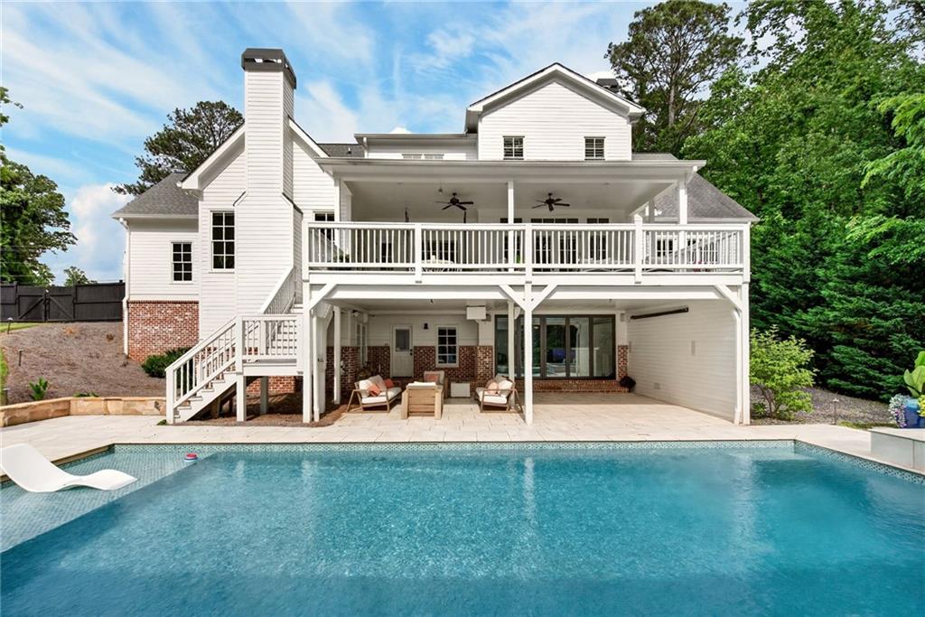 13460 New Providence Road Milton, GA 30004 - Photo 54 of 60 a view of a white house with a big yard and large trees