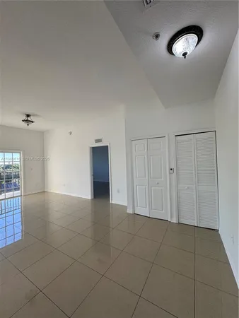 an empty room with projector and fan