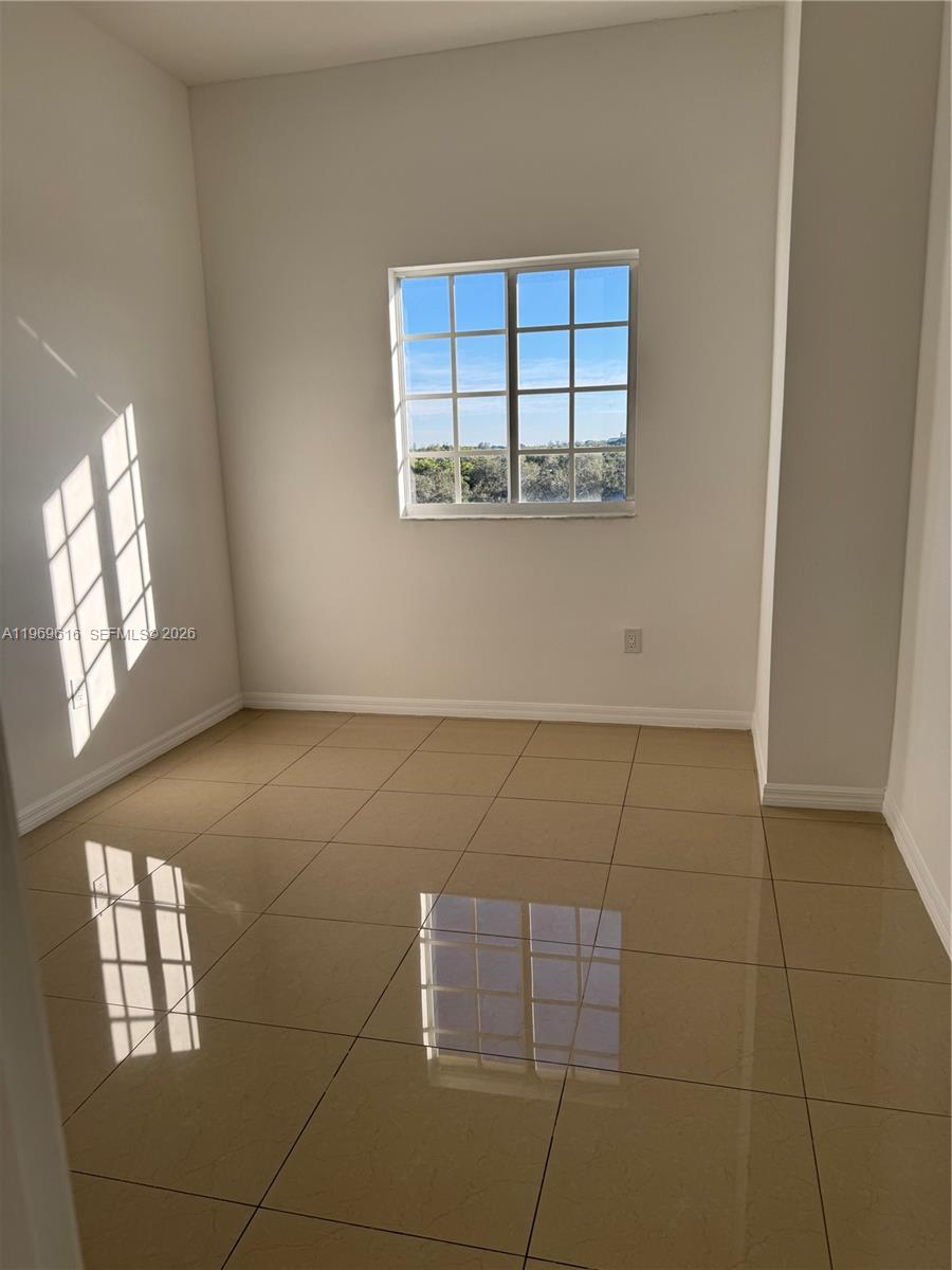 5271 Southwest 8th Street, Unit 503 Miami, FL 33134 - Photo 6 of 13 an empty room with windows