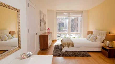 a bedroom with a bed and a couch