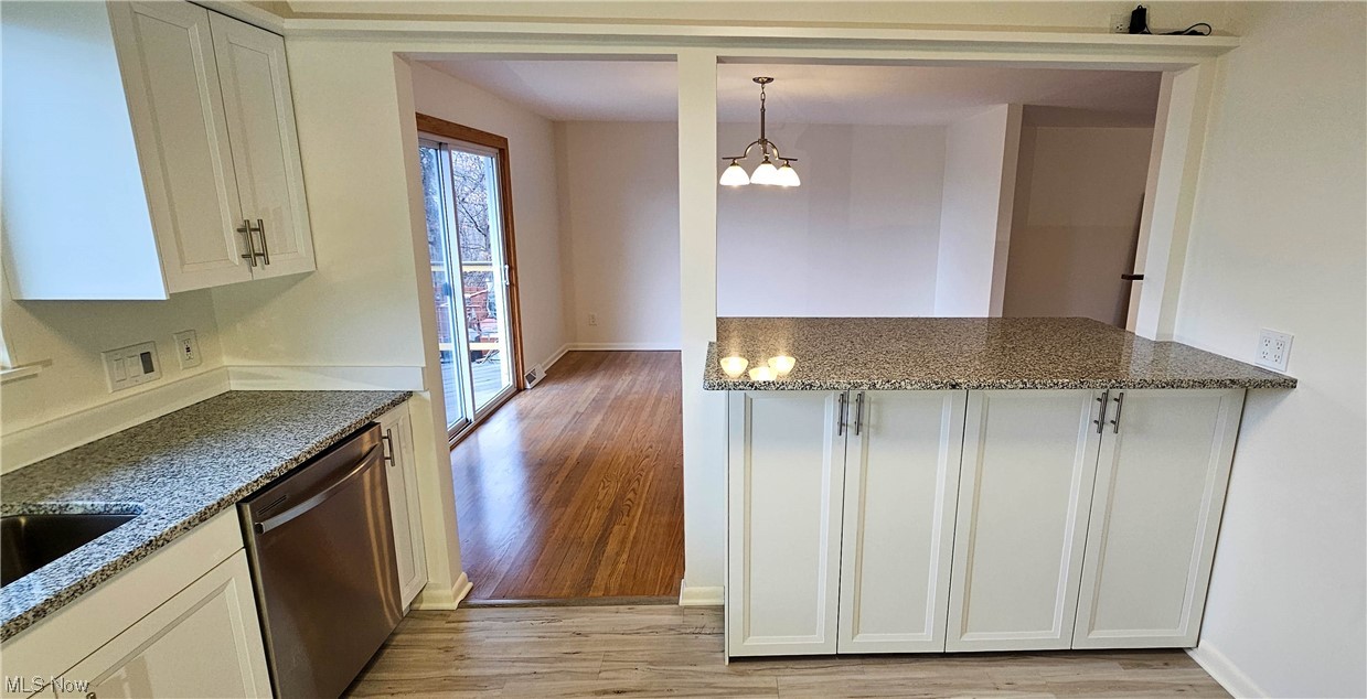 19755 Upper Terrace Road Euclid, OH 44117 - Photo 5 of 38 New kitchen with granite counters and newer Samsung stainless steel appliances and luxury vinyl tile flooring.