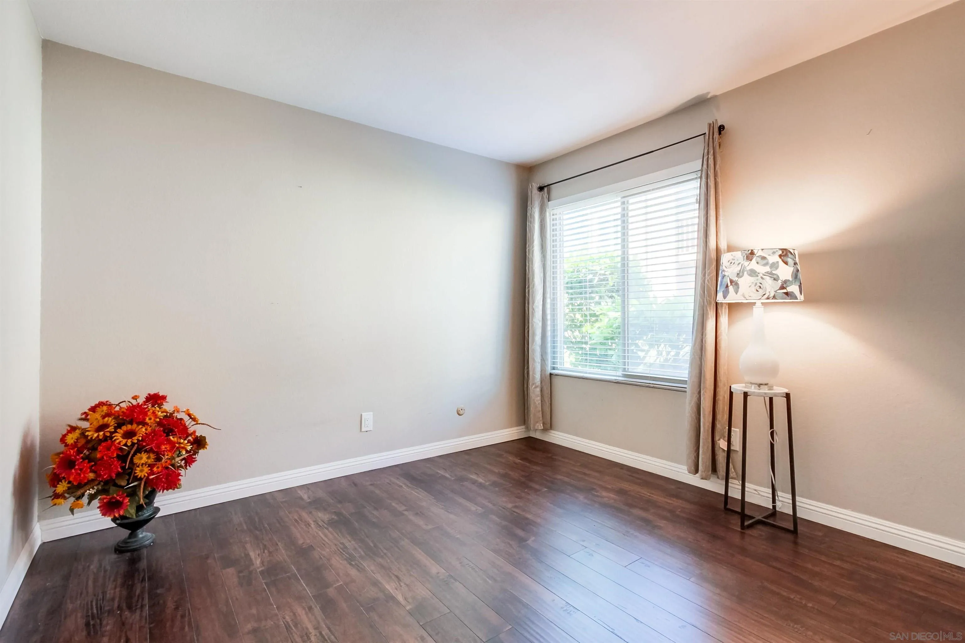 5970 Rancho Mission Road, Unit 241 San Diego, CA 92108 - Photo 14 of 26 a view of an empty room with wooden floor and a window