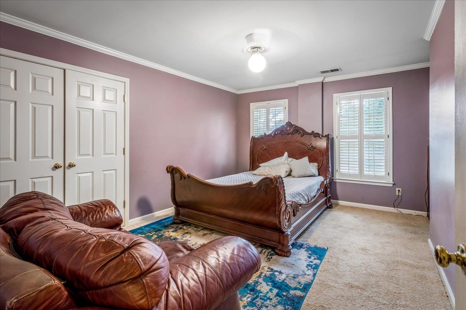 65 Summer Grove Road Memphis, TN 38018 - Photo 27 of 38 White crown molding, dual windows with plantation shutters, twin bifold closet doors, and recessed lighting