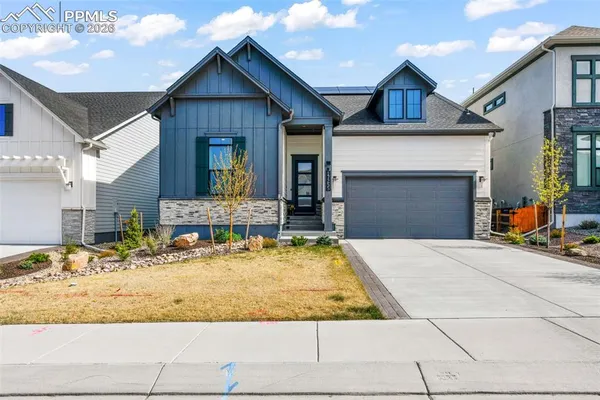 a view of a house with a yard patio and fire pit