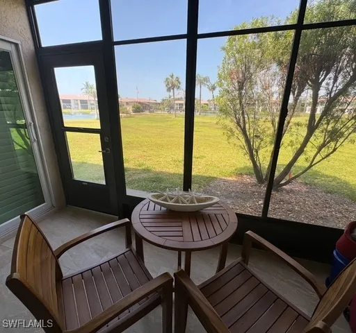 a living room with furniture and a floor to ceiling window