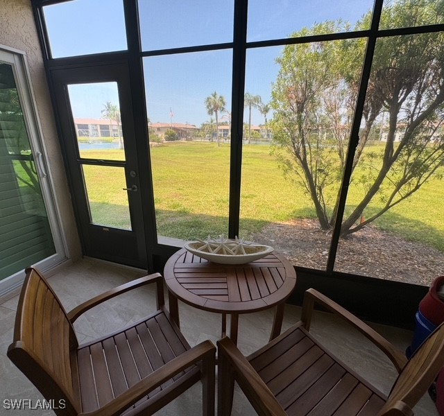 16007 Davis Road, Unit 614 Fort Myers, FL 33908 - Photo 14 of 17 a living room with furniture and a floor to ceiling window