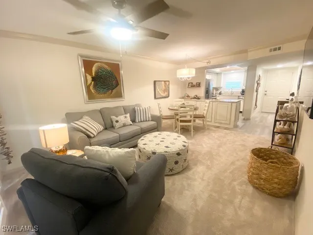 a living room with furniture and a large mirror