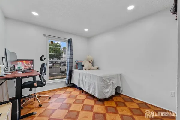a bedroom with furniture and a window