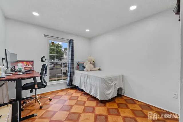 a bedroom with furniture and a window