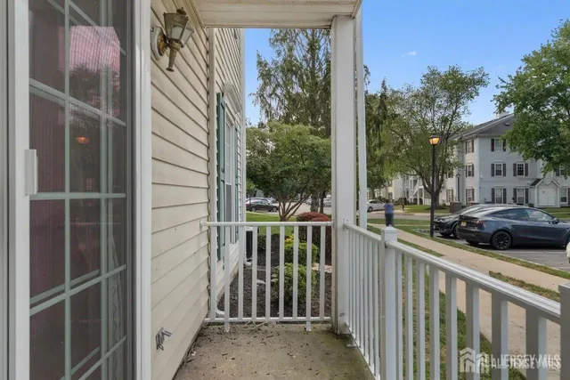 a view of a house with a car park side of a road
