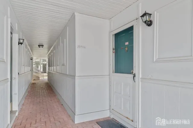 a view of a hallway with a white refrigerator