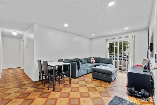 a living room with furniture a rug and a window
