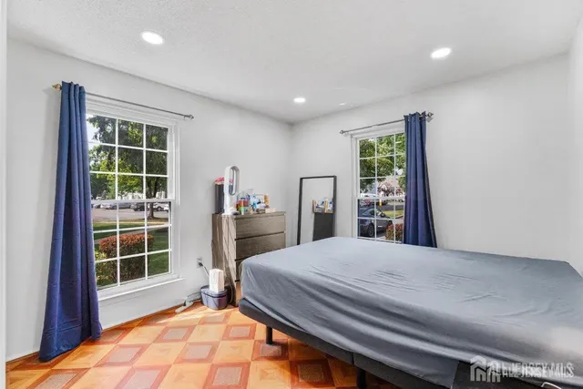 a bedroom with a large bed and a large window