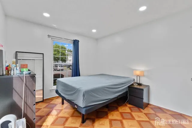 a bedroom with a bed and a dresser