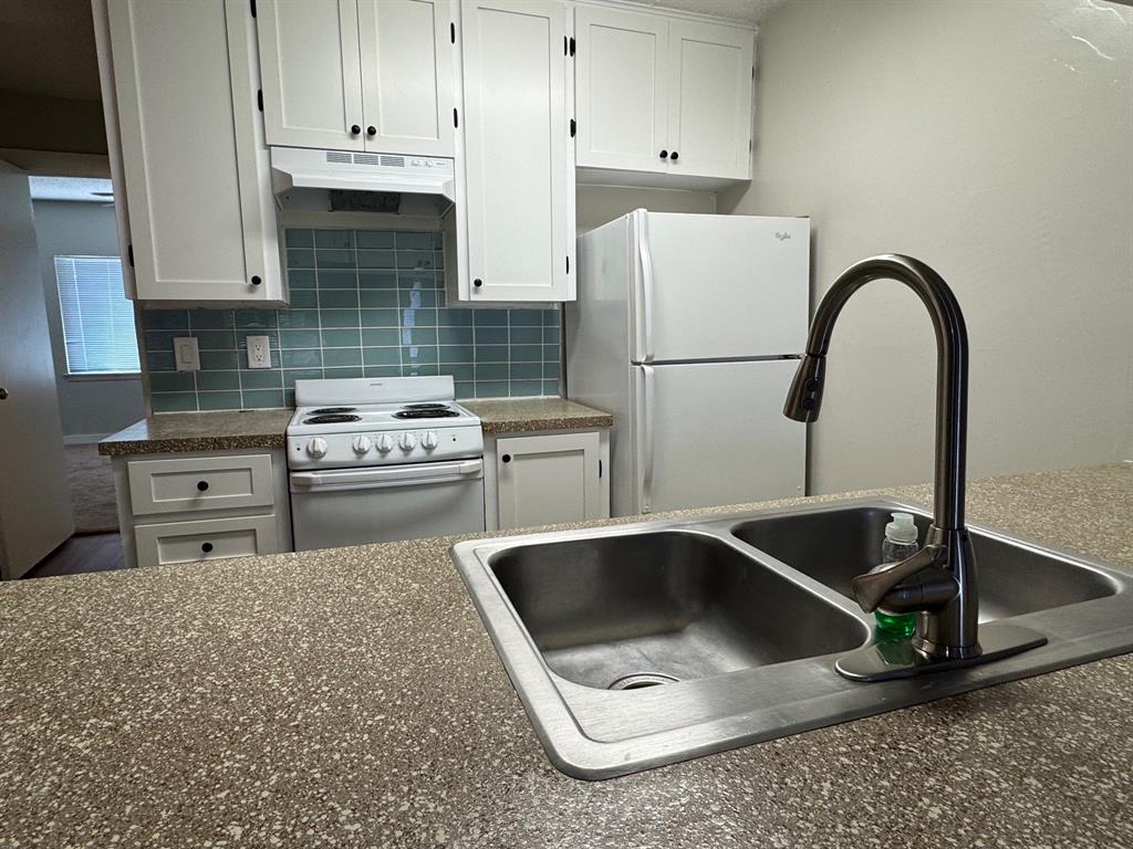 2408 Longview Street, Unit 108 Austin, TX 78705 - Photo 3 of 7 a kitchen with a sink a stove and refrigerator