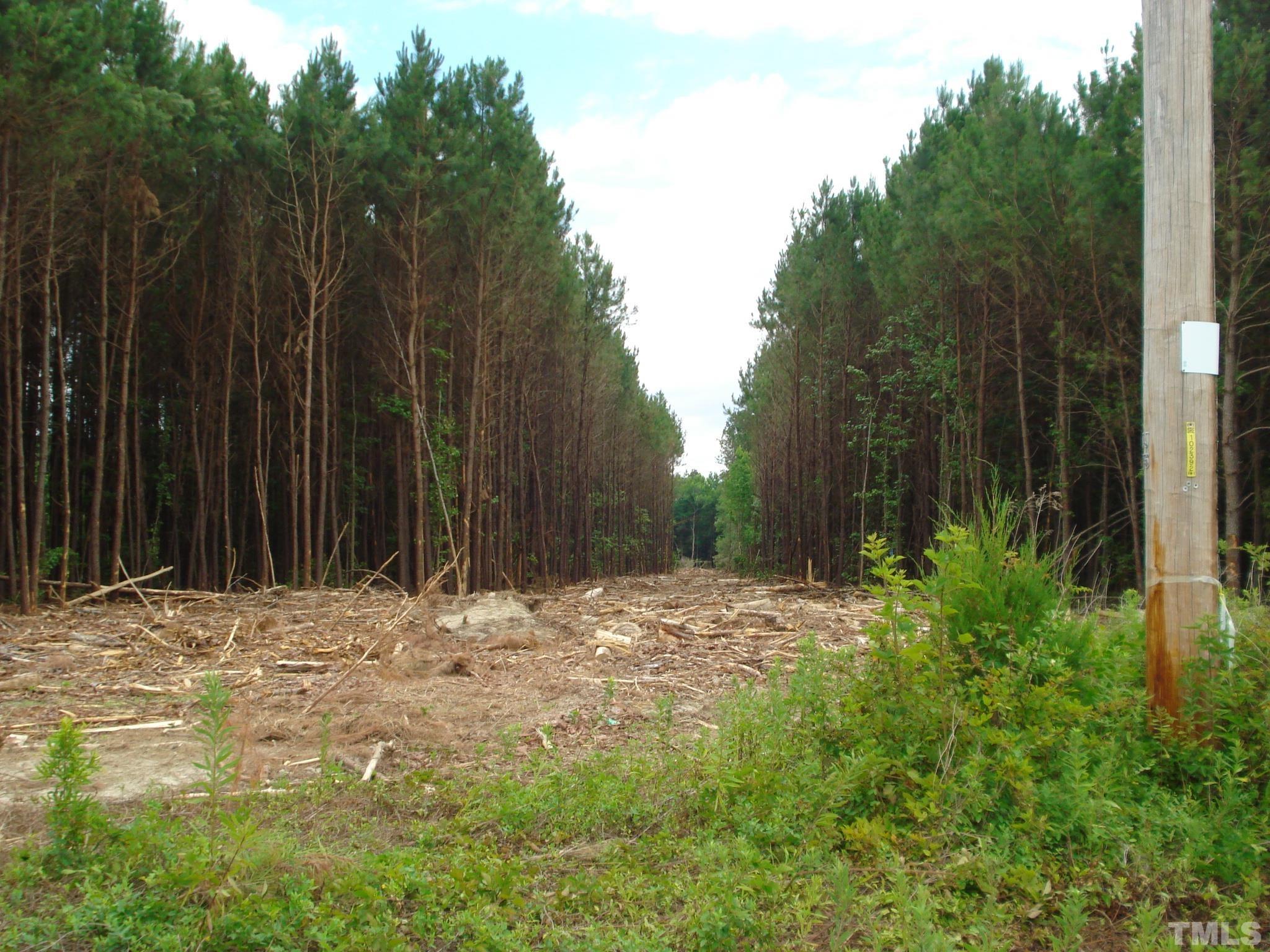 a wooden fence with trees in the background