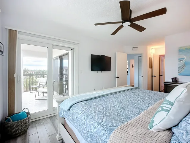 a bedroom with a large bed and a flat screen tv