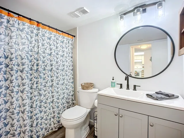 a bathroom with a sink a mirror a toilet and a sink