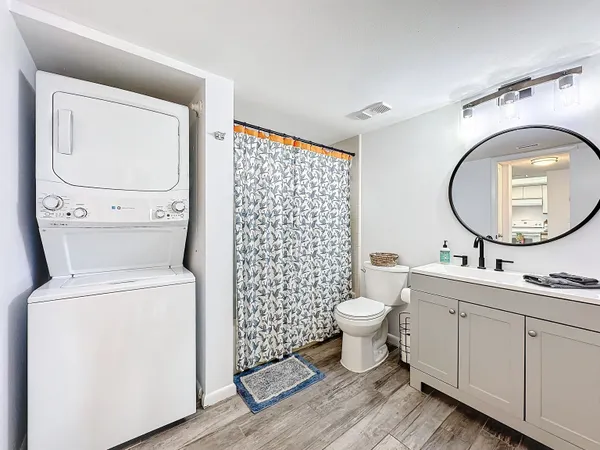 a bathroom with a toilet a sink and a mirror