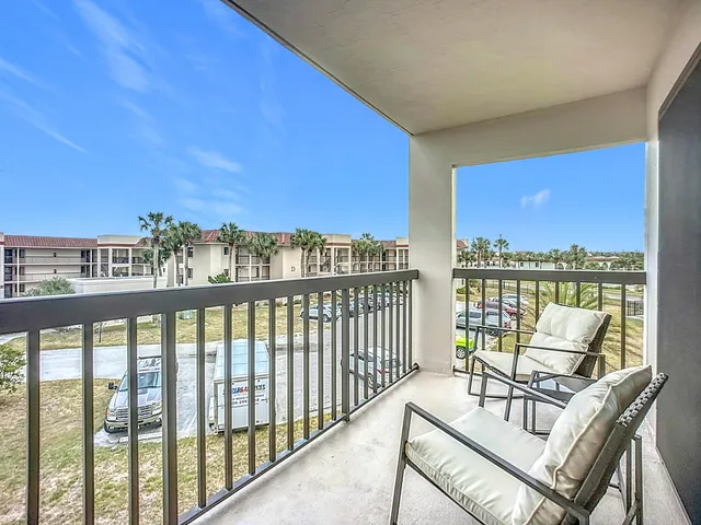 a view of a balcony with chairs