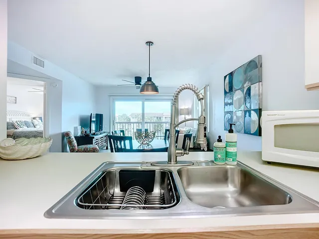 a view of kitchen with a sink and living room