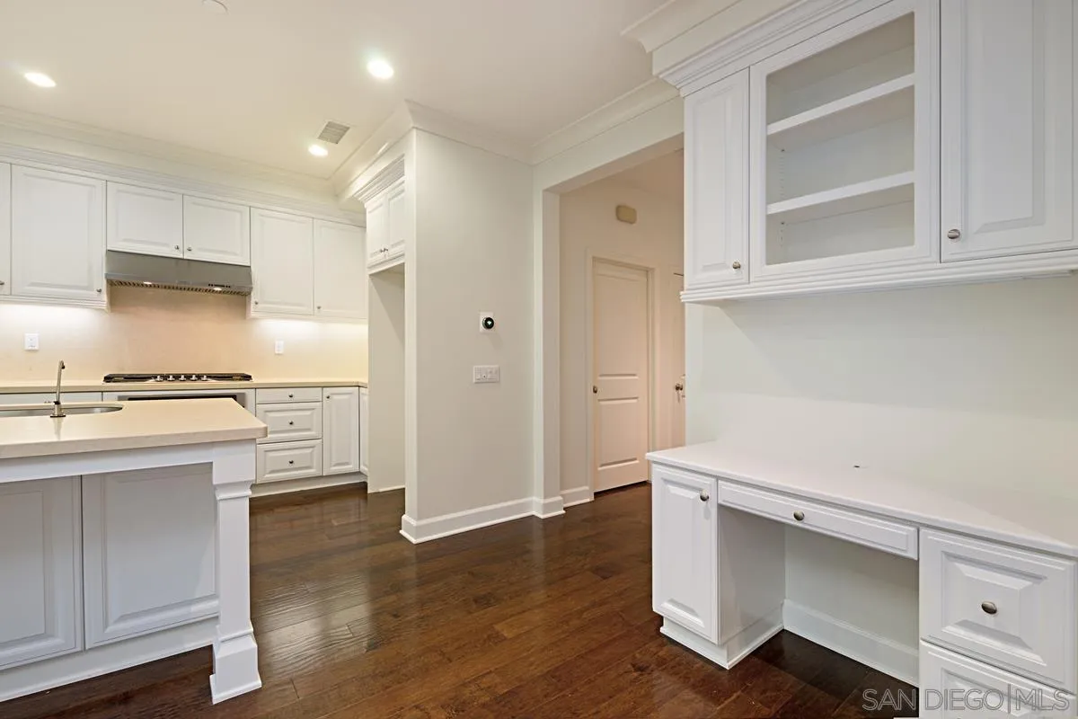 82 Brindisi Irvine, CA 92618 - Photo 12 of 49 a kitchen with a refrigerator and white cabinets