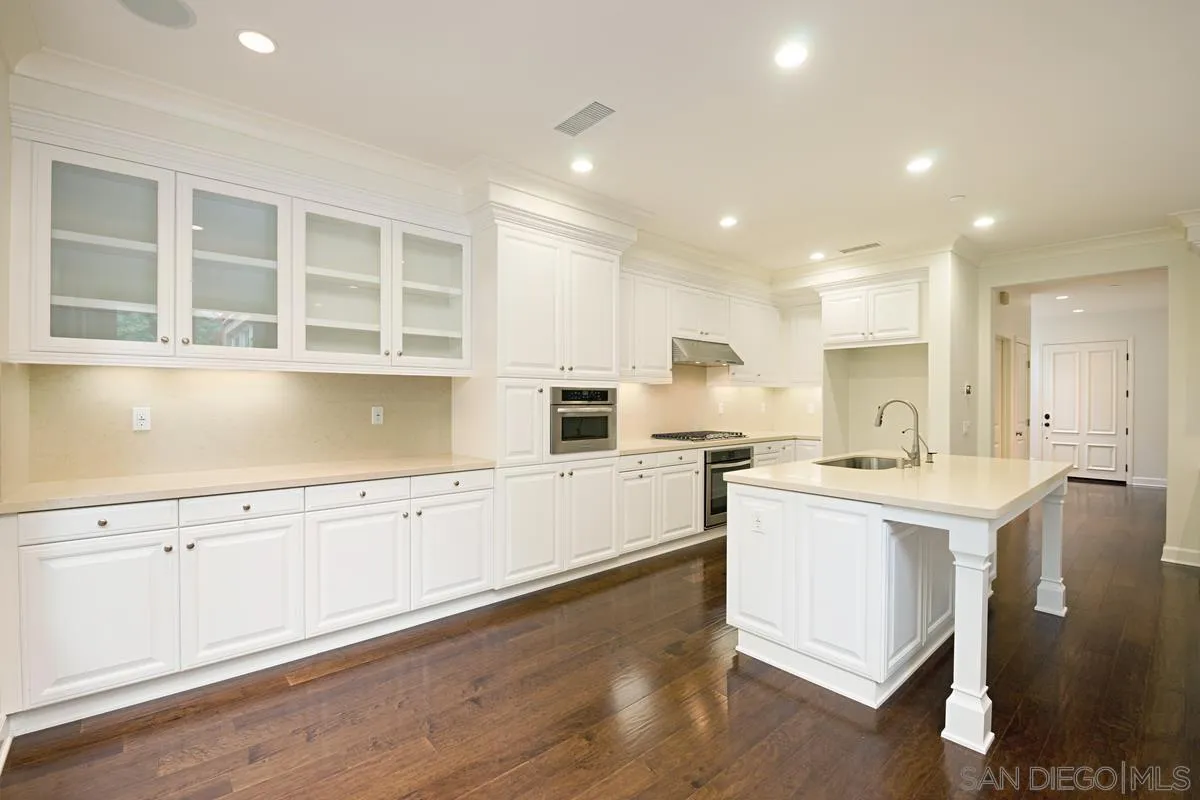 82 Brindisi Irvine, CA 92618 - Photo 15 of 49 a kitchen with a sink stove and cabinets