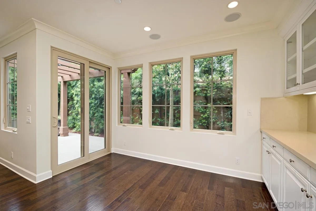 82 Brindisi Irvine, CA 92618 - Photo 19 of 49 a view of an empty room with wooden floor and a window