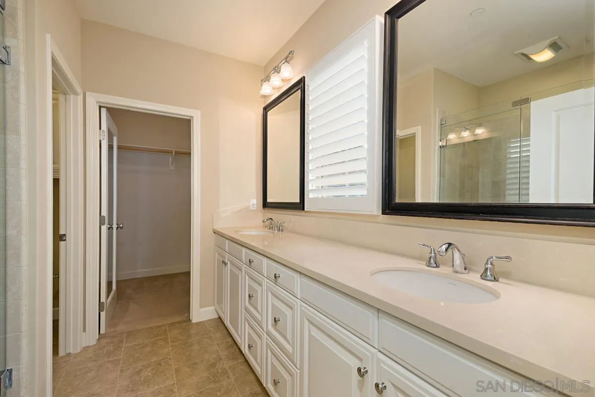 82 Brindisi Irvine, CA 92618 - Photo 24 of 49 a bathroom with double sink and a mirror