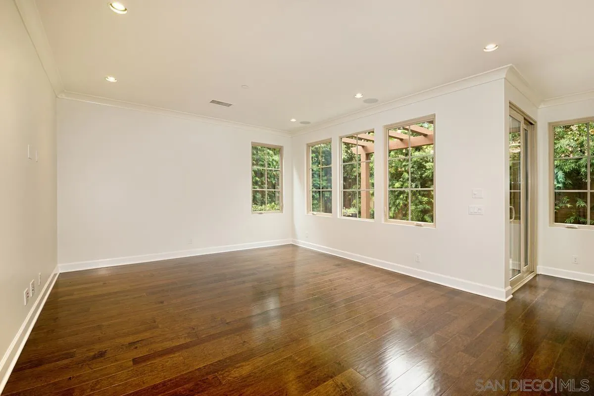 82 Brindisi Irvine, CA 92618 - Photo 10 of 49 an empty room with wooden floor and windows