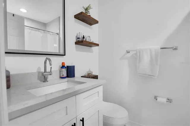 a bathroom with a sink a toilet and mirror